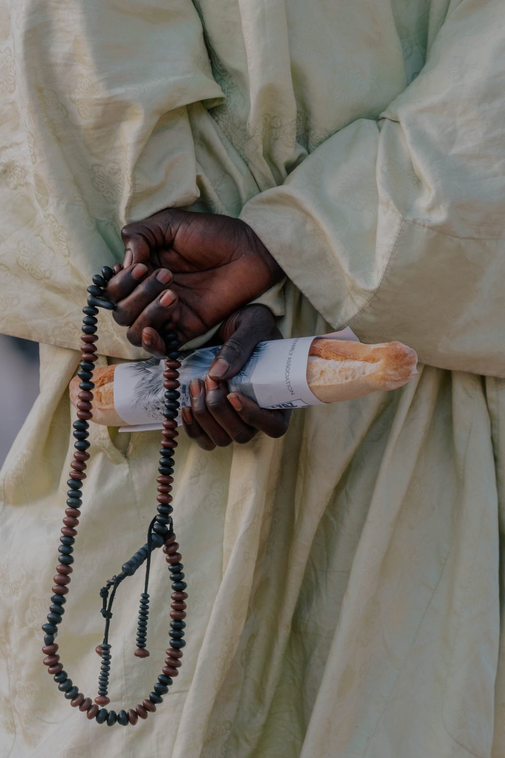 In the warm glow of sunset in the Gambla, hands of every shade and story cradle fresh bread in quiet anticipation of litar. From the bustling streets of serrekunda to the calm neighborhoods of Brikama, elders, youth, market women, students,and workers pause together-bread in hand
